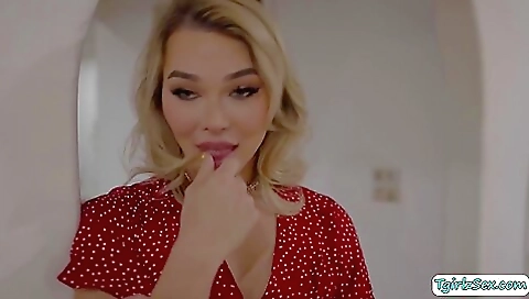 Blonde with long hair is rimming in a bedroom scene