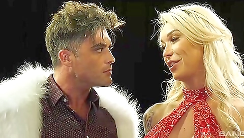 Hot blonde with big tits is standing in front of the camera