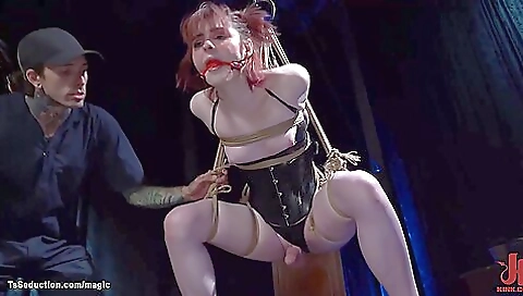 Red-haired bitch in bondage harnesses a dick in her pussy