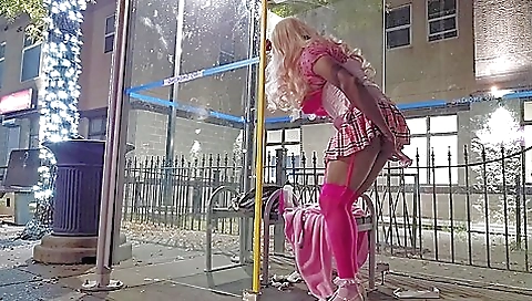 Amateur blonde in the bus rides a toy on the bus stop